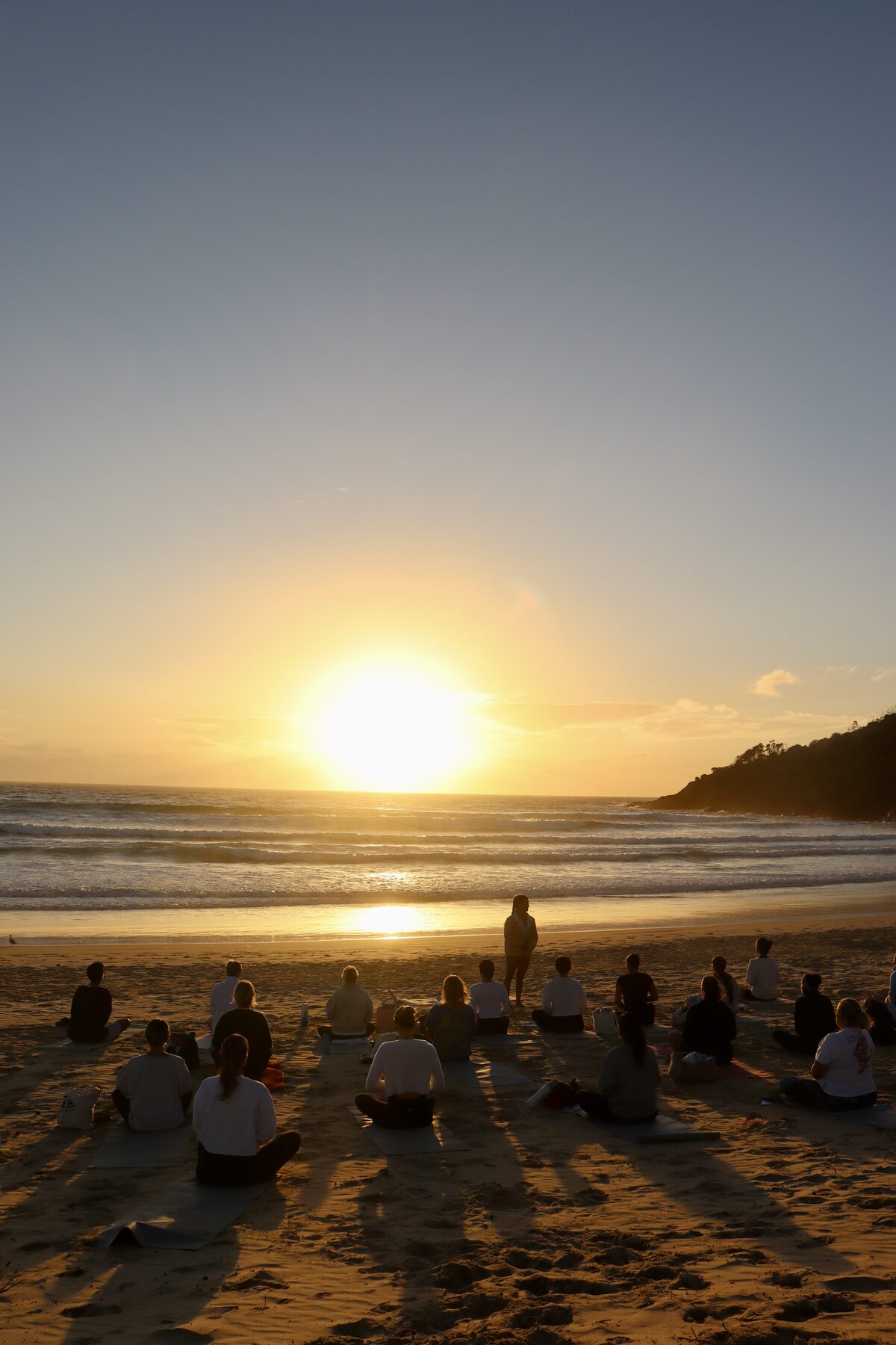 Beach yoga at sunset on One Mile Beach, Port Stephens